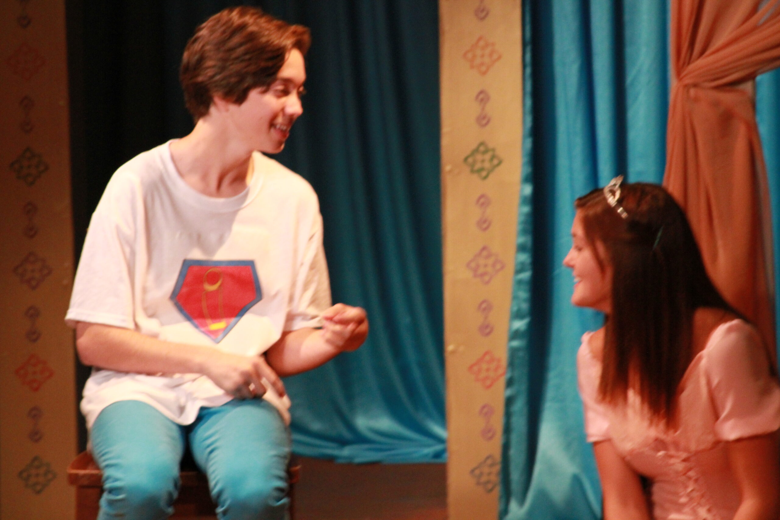 Inky (Scott Sharma) and Princess Penelope (Hannah Nawroth) share a moment before the trial of Sorcerer Slurm begins in the World Premiere of Super Sidekick: The Musical, presented by Theatre Unleashed at The Sherry Theater in North Hollywood, CA