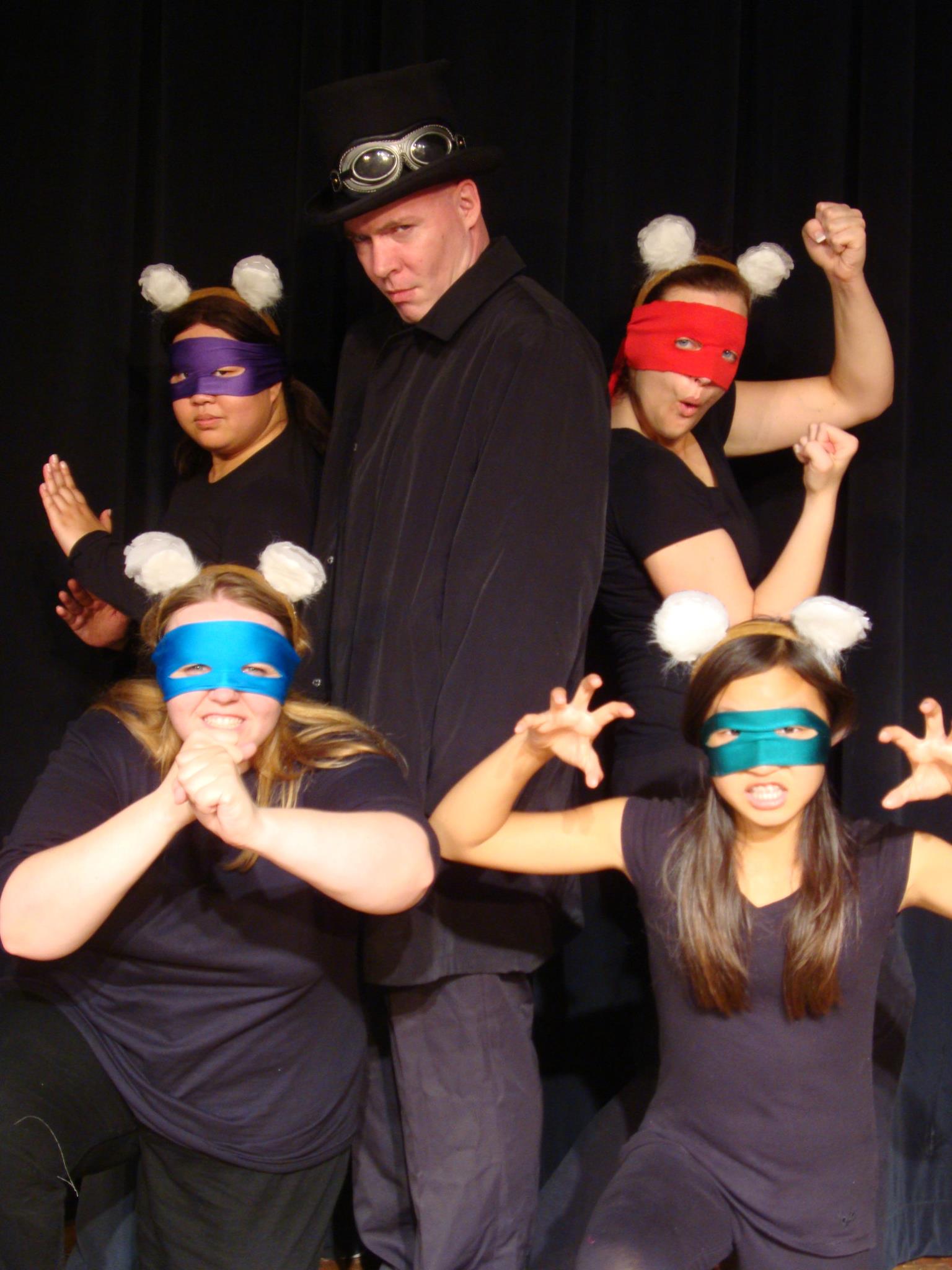 Sorcerer Slurm (Shawn Cahill), flanked by the Ninja Koalas (Ana Therese Lopez, Heather Lake, Katelin Han, and Beth Wallan) as seen in the 2011 Best of Hollywood Fringe run of Super Sidekick: The Musical, presented by Theatre Unleashed at Theatre Asylum in Los Angeles, CA